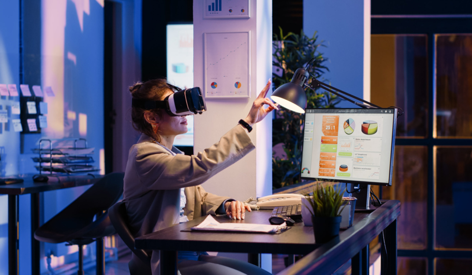 Young businesswoman working with vr glasses at night, working overtime on economy development in office. Female manager using virtual reality headset, planning financial diagrams report on pc.